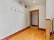 Bright hallway with hardwood floors and coat hooks at 720 E 400 N, Anderson, IN 46012