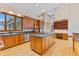 Island kitchen with granite counters, wood cabinets, and stainless steel appliances at 720 E 400 N, Anderson, IN 46012