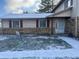 Brick ranch home with snow-covered lawn and a welcoming front entrance at , Indianapolis, IN 46229