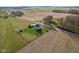 House nestled in farmland, aerial view showcasing its rural setting at 1497 N Matthews Rd, Greenwood, IN 46143