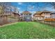 Spacious backyard with grassy lawn, wooden fence, and patio at 3618 N Pennsylvania St, Indianapolis, IN 46205