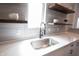 Sleek kitchen sink and faucet with white quartz countertops and wood floating shelves at 722 E Minnesota St, Indianapolis, IN 46203