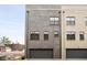 Modern townhome with gray and beige brick exterior and attached garage at 1224 Alabama St, Indianapolis, IN 46202