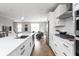 Modern kitchen with white cabinets, a large island, and hardwood floors at 1224 Alabama St, Indianapolis, IN 46202