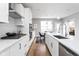 Modern kitchen with white cabinets, quartz counters, and stainless steel appliances at 1224 Alabama St, Indianapolis, IN 46202