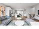 Open concept living room and kitchen with hardwood floors and stylish furniture at 1224 Alabama St, Indianapolis, IN 46202