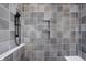 Walk-in shower with gray tile and built-in shelves at 1224 Alabama St, Indianapolis, IN 46202