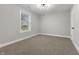 Spacious bedroom with neutral walls, plush carpeting, and a window with blinds at 1519 N Beville Ave, Indianapolis, IN 46201