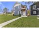 Two-story home with gray siding, white trim, and a landscaped yard at 1519 N Beville Ave, Indianapolis, IN 46201