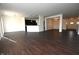 Open living room with dark hardwood floors and kitchen view at 1717 N Creekwater Pass, Greenfield, IN 46140