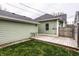 View of backyard with wooden deck and green grass at 2312 E Woodlawn Ave, Indianapolis, IN 46203