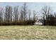 Open field with tall grass and a small house in the distance at 2750 N County Road 1000 E, Indianapolis, IN 46234