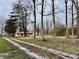 White farmhouse with red roof sits on a grassy lot at 2750 N County Road 1000 E, Indianapolis, IN 46234