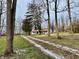 White farmhouse with red roof sits on a grassy lot at 2750 N County Road 1000 E, Indianapolis, IN 46234