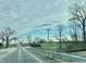 Asphalt road leads to a mostly flat, open field at 2750 N County Road 1000 E, Indianapolis, IN 46234