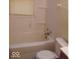 Small bathroom with a bathtub, toilet, and window blinds at 3726 N Emerson Ne Ave, Indianapolis, IN 46218
