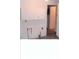 Kitchen needing updates, white cabinets, and a view of the hallway at 3726 N Emerson Ne Ave, Indianapolis, IN 46218