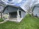 Gray house with a front porch and small yard at 4102 Spann Ave, Indianapolis, IN 46203