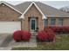 Brick front of home with attached garage and red landscaping at 4643 Kensington N Way, Plainfield, IN 46168