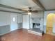 Living room with fireplace, hardwood floors and ceiling fan at 504 E Park St, Trafalgar, IN 46181