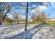 Landscaped backyard with trees and light dusting of snow at 9464 Maple Way # 27, Indianapolis, IN 46268