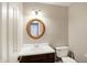 Simple bathroom with wood vanity and oval mirror at 9464 Maple Way # 27, Indianapolis, IN 46268