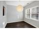 Dining room with large light fixture and dark floors at 9464 Maple Way # 27, Indianapolis, IN 46268