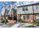 Brick front townhouse with green door, walkway, and landscaping at 9464 Maple Way # 27, Indianapolis, IN 46268