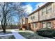 Brick townhouse with walkway, landscaping, and snowy ground at 9464 Maple Way # 27, Indianapolis, IN 46268