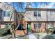 Brick front townhouse with green door, walkway, and landscaping at 9464 Maple Way # 27, Indianapolis, IN 46268