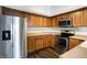 Modern kitchen with stainless steel appliances and wood cabinets at 9464 Maple Way # 27, Indianapolis, IN 46268