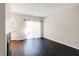Living room with fireplace, patio doors, and dark floors at 9464 Maple Way # 27, Indianapolis, IN 46268