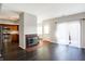 Living room with fireplace, dark floors, and kitchen view at 9464 Maple Way # 27, Indianapolis, IN 46268