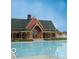 Community pool and clubhouse with classic architecture at 12938 University Cres # Apt 2B, Carmel, IN 46032