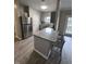 Modern kitchen with granite countertop and stainless steel refrigerator at 12938 University Cres # Apt 2B, Carmel, IN 46032