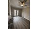 Living room with hardwood floors and access to balcony at 12938 University Cres # Apt 2B, Carmel, IN 46032