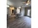 Open living area with hardwood floors and kitchen island at 12938 University Cres # Apt 2B, Carmel, IN 46032