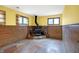 Finished basement with wood paneling, stone fireplace, and large windows at 13832 W Old Nashville Rd, Columbus, IN 47201