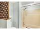 Bathroom with a tub and shower combination, and a wood lattice partition at 13832 W Old Nashville Rd, Columbus, IN 47201