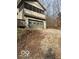 Two-car garage with gravel driveway and partially visible deck at 13832 W Old Nashville Rd, Columbus, IN 47201