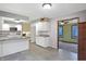 Modern kitchen with white cabinetry, granite countertops, and an island at 13832 W Old Nashville Rd, Columbus, IN 47201