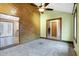 Bright living room with a wood-paneled accent wall, fireplace, and access to other rooms at 13832 W Old Nashville Rd, Columbus, IN 47201
