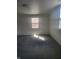 Spacious bedroom with grey carpet and window at 1826 N Dexter St, Indianapolis, IN 46202
