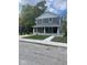 Two-story gray house with white accents, front porch, and landscaped yard at 1826 N Dexter St, Indianapolis, IN 46202