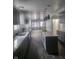 Open concept kitchen with gray cabinets, island, and stainless steel appliances at 1826 N Dexter St, Indianapolis, IN 46202