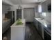 Modern kitchen with gray cabinets, island, stainless steel appliances, and vinyl flooring at 1826 N Dexter St, Indianapolis, IN 46202