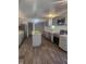 Modern kitchen with gray cabinets, island, stainless steel appliances, and vinyl flooring at 1826 N Dexter St, Indianapolis, IN 46202