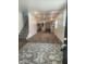 Living room with hardwood floors, kitchen view, and area rug at 1826 N Dexter St, Indianapolis, IN 46202