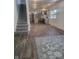 Open living area with kitchen view, hardwood floors, and area rug at 1826 N Dexter St, Indianapolis, IN 46202
