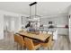 Kitchen and dining area with a large wooden table and pendant lighting at 7526 Allesley Dr, Avon, IN 46123